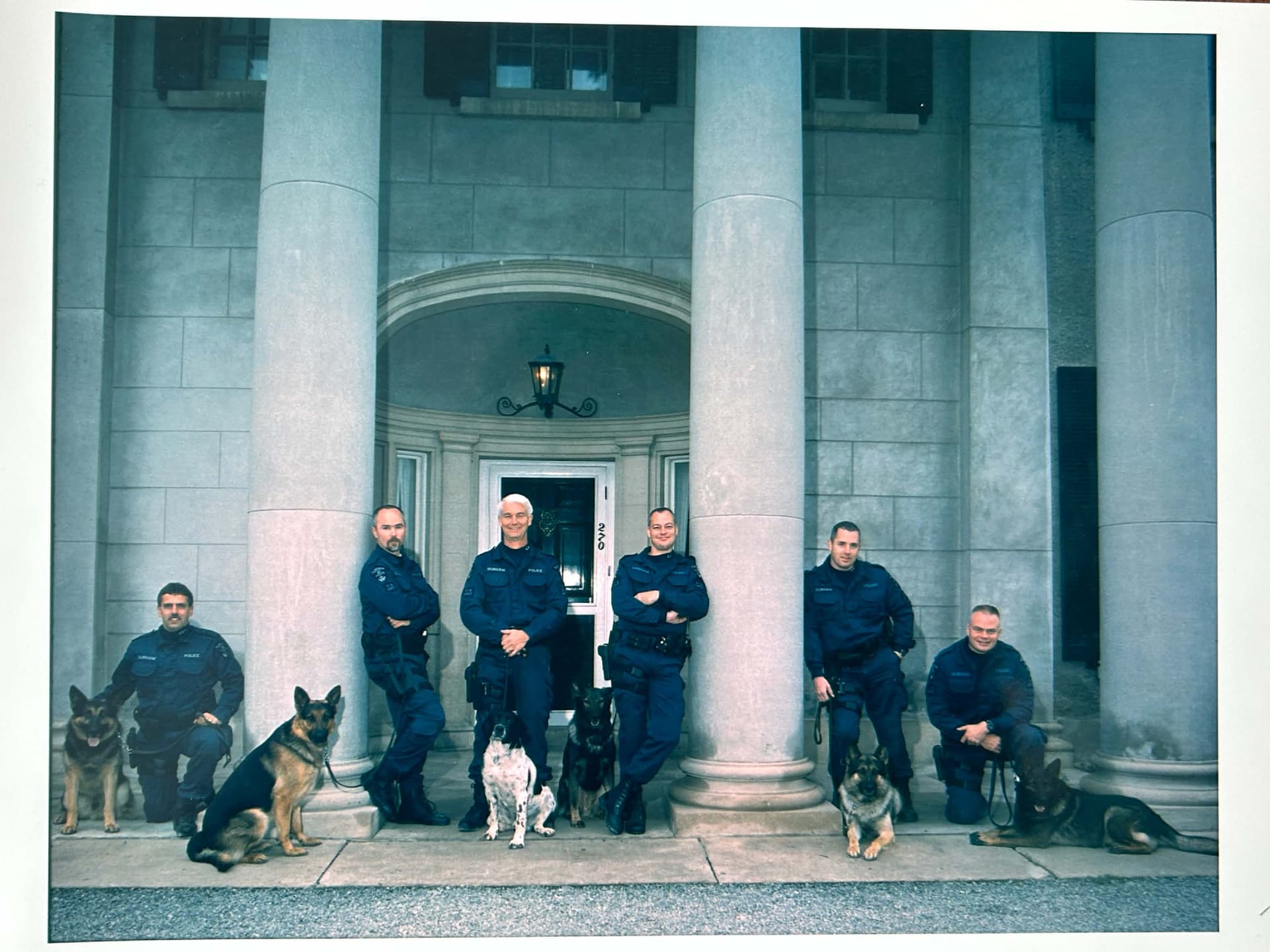 A group of police officers standing in front of a building