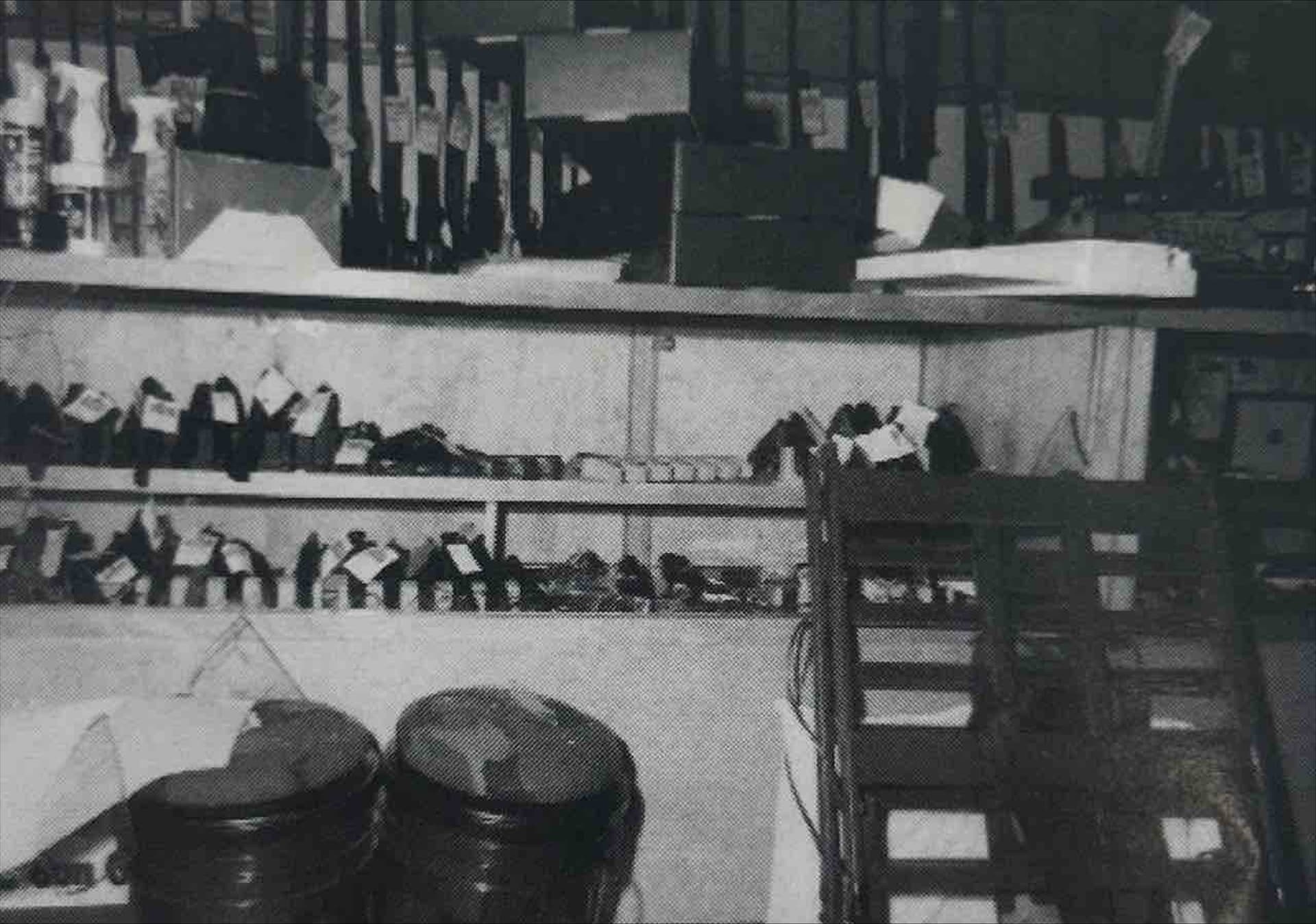 A black and white photo of a shelf filled with items