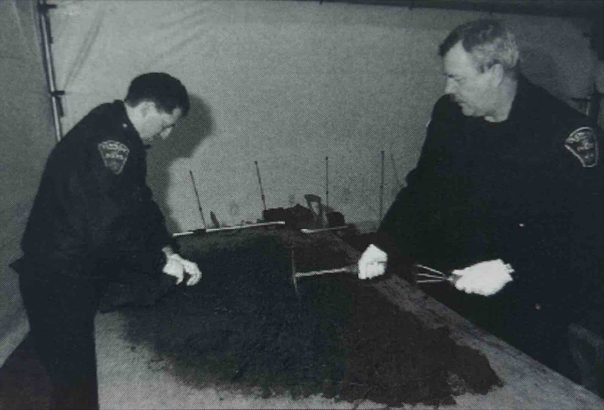 A black and white photo of two men in a room